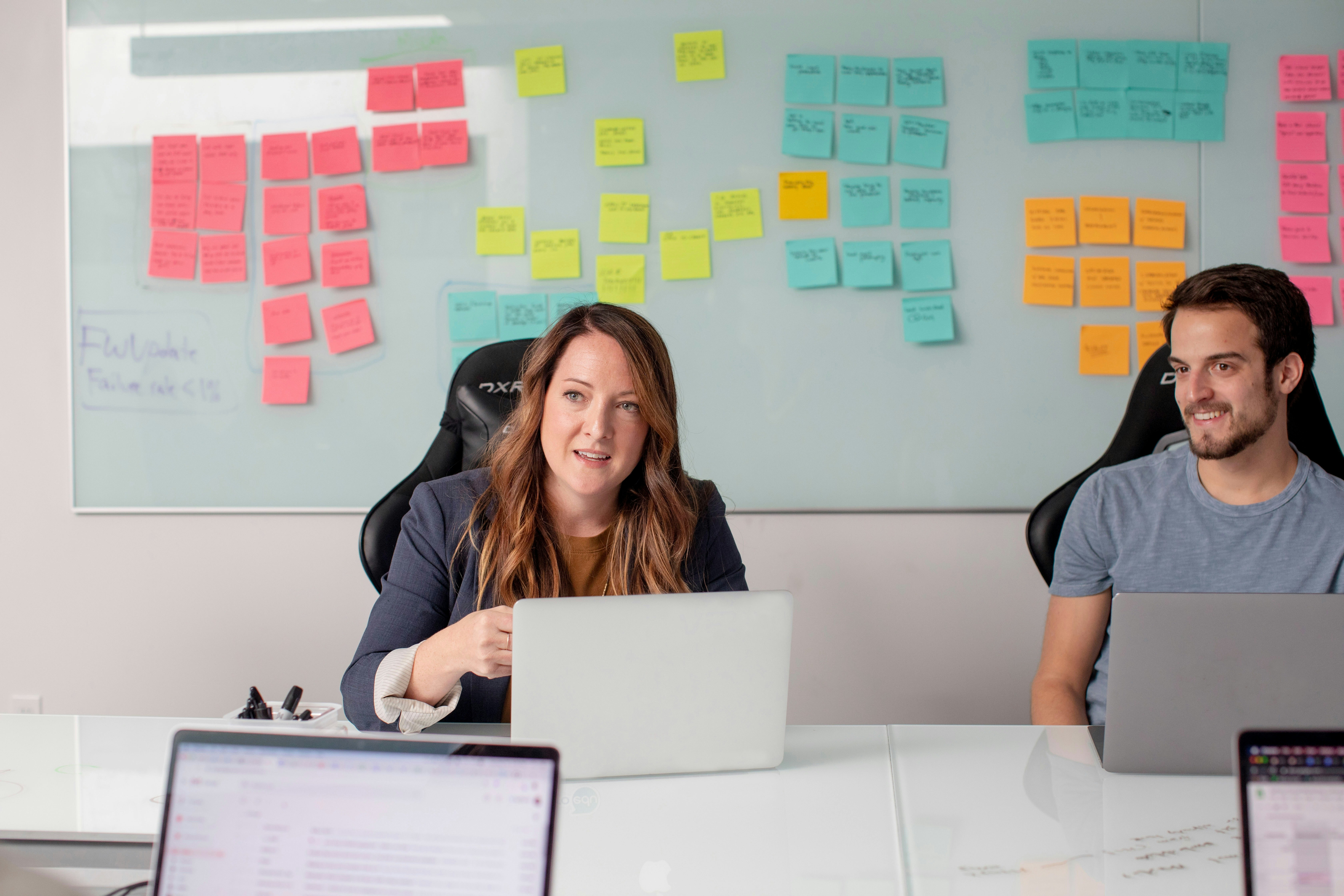 Professional team collaborating on AI strategy with colorful sticky notes on whiteboard
